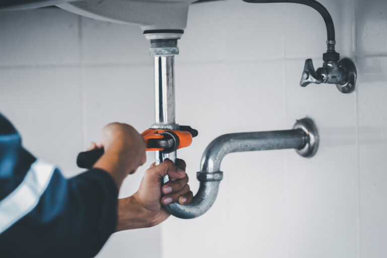 plumber at work in a bathroom, plumbing repair service, assemble